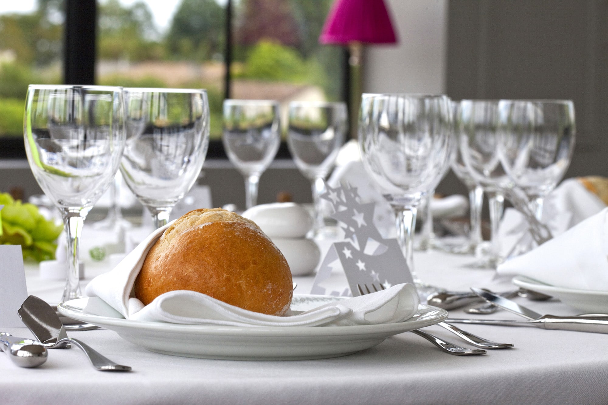 Close up of a table set for a luxurious wedding banquet